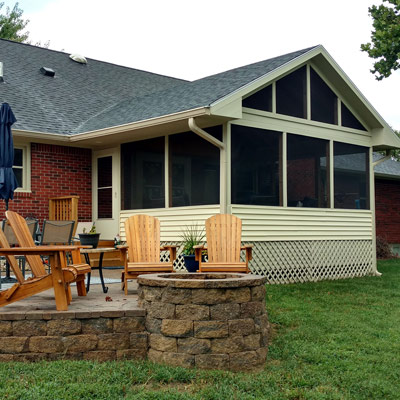 fire pit next to screened in porch
